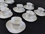a lot of cups and saucers on the table