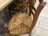 a wooden table with two chairs next to it
