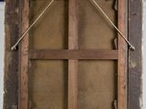 an old wooden easel with a piece of paper hanging from the top of it