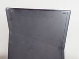 a laptop and a remote on a white table