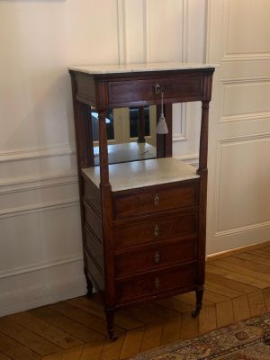 a small wooden cabinet with a mirror on top of it