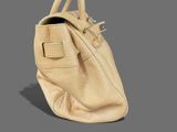 beige leather handbag on grey background with clipping for text