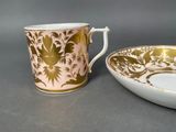 a cup and saucer sitting next to each other on a table