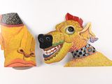 two paper sculptures of a dog and a cat on a shelf