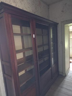 a large wooden cabinet in the middle of a room