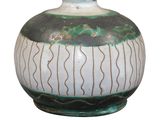 a green and white vase sitting on a white surface