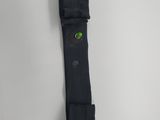 the back of a black belt with a green button on it