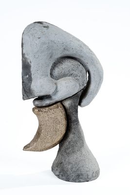 a stone sculpture of a man with a half moon on his head