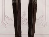 tall brown boots with fur linings on a wooden floor