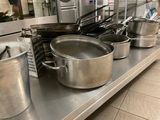 many pots and pans on the counter in the kitchen