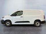 the white van is parked in a room with a gray floor