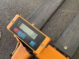 a close up of a wooden bench with a digital device on it