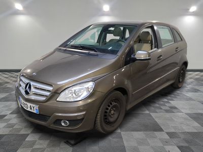 a picture of a brown mercedes b - class parked in a garage