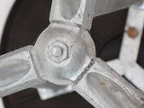a close up of a metal object on a white surface