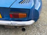 a blue car parked on the side of the road