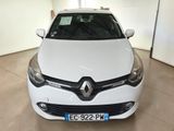 the front view of a white car in a garage