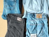Plusieurs paires de jeans sont posées sur une boîte en carton