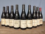 several bottles of wine are lined up on a wooden table