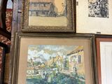 many framed pictures on a table in a room