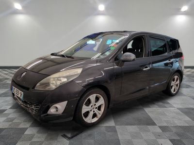 the small black car is parked on a checkered tile floor