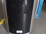 an image of a black and silver refrigerator in a garage
