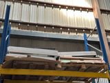 a large stack of wood on a pallet in a warehouse