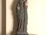 a statue of a woman holding a child on top of a table