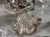 a silver tea pot sitting on top of a table next to glassware