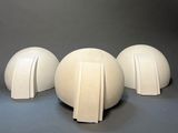 three white vases sitting next to each other on a table