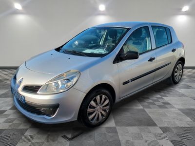 the small silver car is parked in a large room