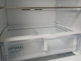 an empty refrigerator with the door open and the freezer door open
