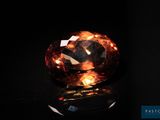 un gros diamant orange sur un fond noir