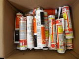 a cardboard box filled with different types of glue