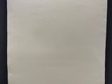 une feuille de papier blanche accrochée à un mur noir