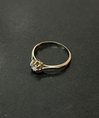 a close up of a diamond ring on a black surface