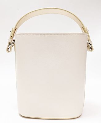 a white bucket bag with a gold handle