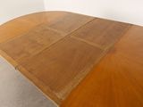 an image of a wooden table with four leaves on top of it