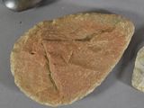 a piece of bread and a rock on a table