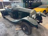 an old car that is sitting in the parking lot
