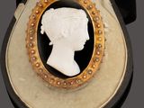 a black and white picture of a woman ' s head in a gold frame