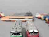 several toy trains are lined up on a table in a room