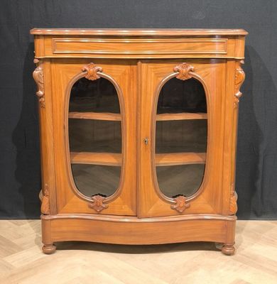 a wooden cabinet with two glass doors on top of it