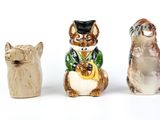 trois figurines de chats assis les uns à côté des autres