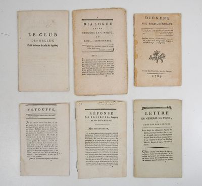 several old books are lined up on a white surface