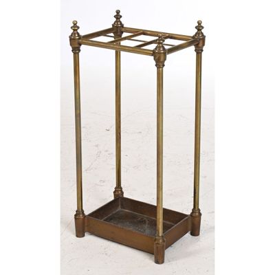 an antique brass metal and glass side table with four posts
