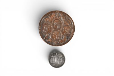 a close up of a coin and a coin on a white surface