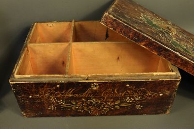 an old wooden box sitting on top of a table next to another box