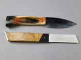 two knives that are sitting next to each other on a table