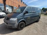 the van is parked in front of a brick building
