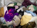 many different types of hats and purses in a basket